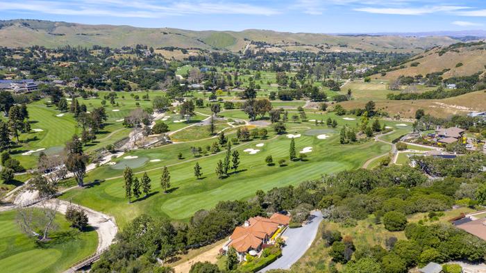 CLOUT aerial over a golf-course community and open land
